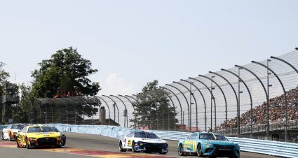 WATKINS GLEN, NEW YORK - AUGUST 20: Denny Hamlin, driver of the #11 Mavis Tires & Brakes Toyota,William Byron, driver of the #24 Valvoline Chevrolet, and Michael McDowell, driver of the #34 Love's Travel Stops Ford, race during the NASCAR Cup Series Go Bowling at The Glen at Watkins Glen International on August 20, 2023 in Watkins Glen, New York. (Photo by Chris Graythen/Getty Images) | Getty Images
