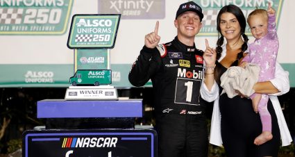 HAMPTON, GEORGIA - JULY 08: John Hunter Nemechek, driver of the #20 Mobil 1 Toyota, celebrates with his wife, Taylor Nemechek, and daughter, Aspen Palmer Nemechek in victory lane after winning the NASCAR Xfinity Series Alsco Uniforms 250 at Atlanta Motor Speedway on July 08, 2023 in Hampton, Georgia. (Photo by Chris Graythen/Getty Images) | Getty Images