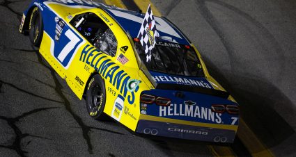 DAYTONA BEACH, FLORIDA - AUGUST 25: Justin Allgaier, driver of the #7 Hellmann's Chevrolet, drives with the checkered flag after winning the NASCAR Xfinity Series Wawa 250 powered by Coca-Cola at Daytona International Speedway on August 25, 2023 in Daytona Beach, Florida. (Photo by James Gilbert/Getty Images) | Getty Images