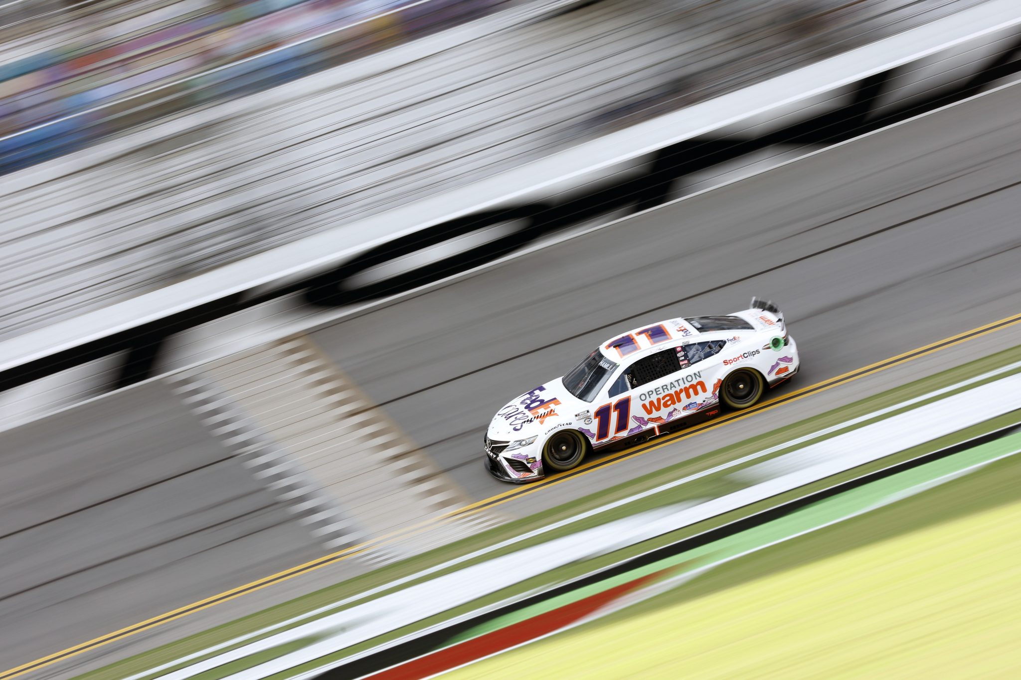 DAYTONA BEACH, FLORIDA - AUGUST 25: Denny Hamlin, driver of the #11 FedEx Cares Toyota, drives during qualifying for the NASCAR Cup Series Coke Zero Sugar 400 at Daytona International Speedway on August 25, 2023 in Daytona Beach, Florida. (Photo by Sean Gardner/Getty Images) | Getty Images