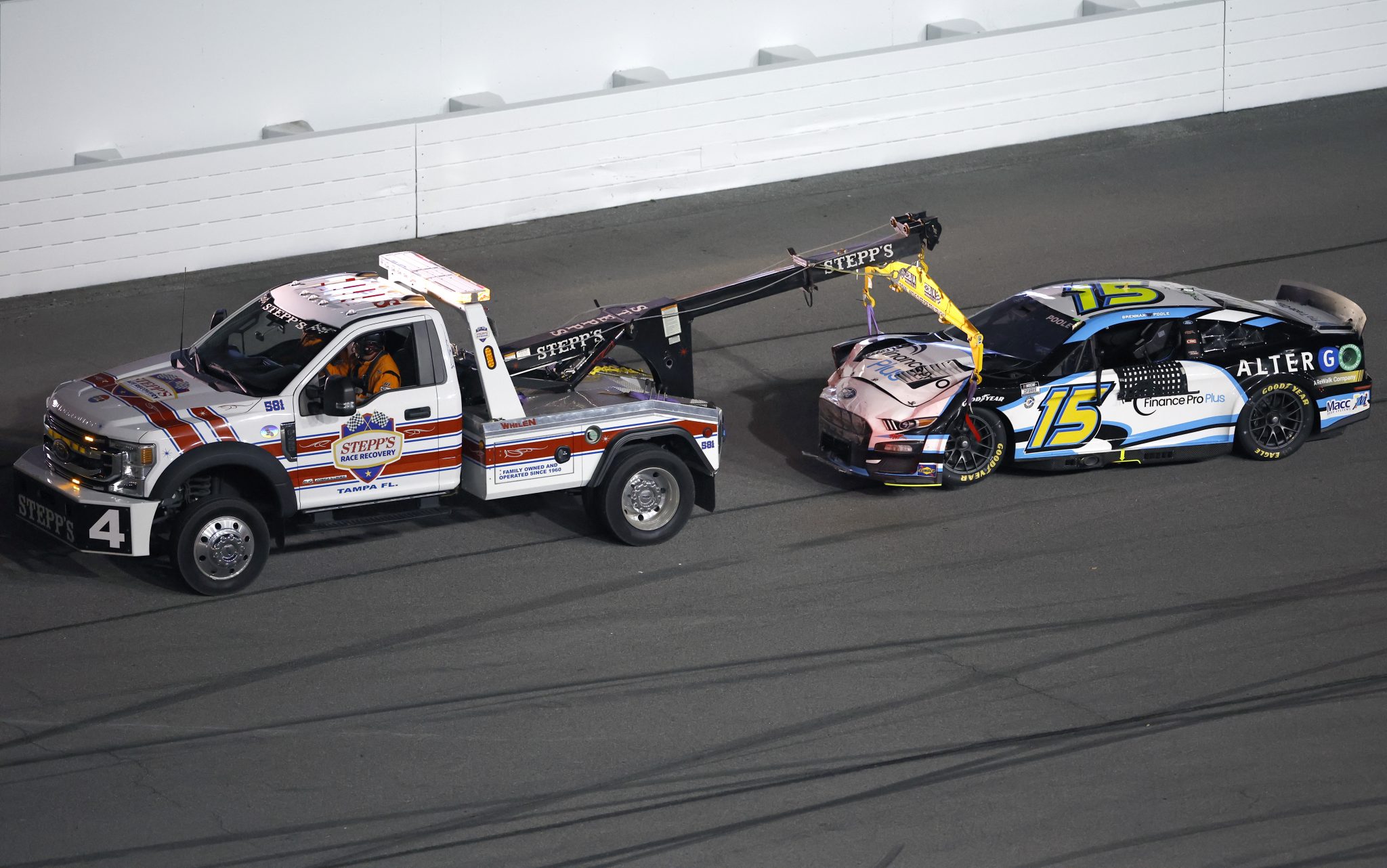 DAYTONA BEACH, FLORIDA - AUGUST 26: The #15 Finance Pro Plus Ford, driven by is towed Brennan Poole is towed after an on-track incident during the NASCAR Cup Series Coke Zero Sugar 400 at Daytona International Speedway on August 26, 2023 in Daytona Beach, Florida. (Photo by James Gilbert/Getty Images) | Getty Images