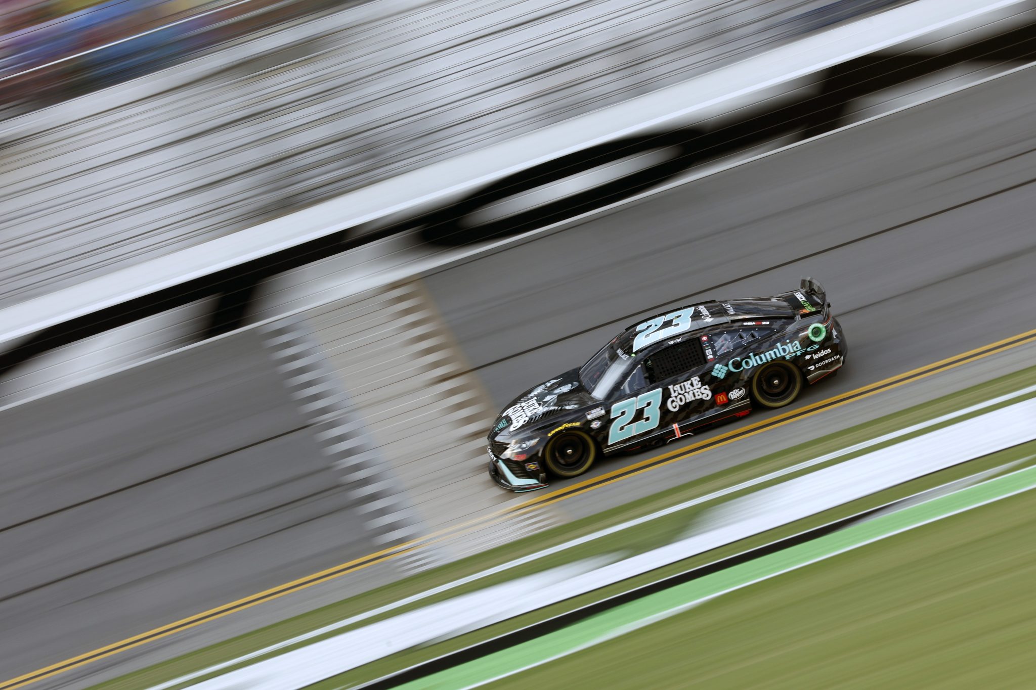 DAYTONA BEACH, FLORIDA - AUGUST 25: Bubba Wallace, driver of the #23 Columbia Sportswear Company Toyota, drives during qualifying for the NASCAR Cup Series Coke Zero Sugar 400 at Daytona International Speedway on August 25, 2023 in Daytona Beach, Florida. (Photo by Sean Gardner/Getty Images) | Getty Images