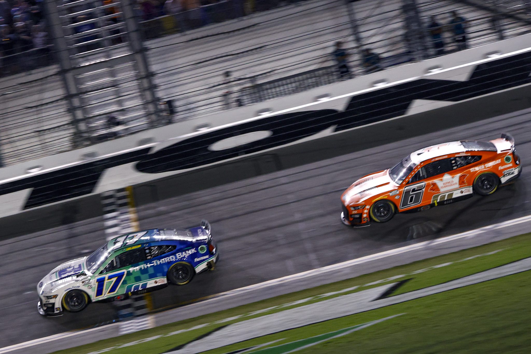 DAYTONA BEACH, FLORIDA - AUGUST 26: Chris Buescher, driver of the #17 Fifth Third Bank Ford, crosses the finish line ahead of Brad Keselowski, driver of the #6 King's Hawaiian Ford, to win the NASCAR Cup Series Coke Zero Sugar 400 at Daytona International Speedway on August 26, 2023 in Daytona Beach, Florida. (Photo by Chris Graythen/Getty Images) | Getty Images