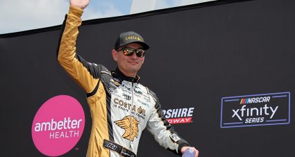 LOUDON, NEW HAMPSHIRE - JULY 15: Ryan Ellis, driver of the #43 Costa Oil Chevrolet, waves to fans as he walks onstage during driver intros prior to  the NASCAR Xfinity Series Ambetter Health 200 at New Hampshire Motor Speedway on July 15, 2023 in Loudon, New Hampshire. (Photo by Jonathan Bachman/Getty Images) | Getty Images
