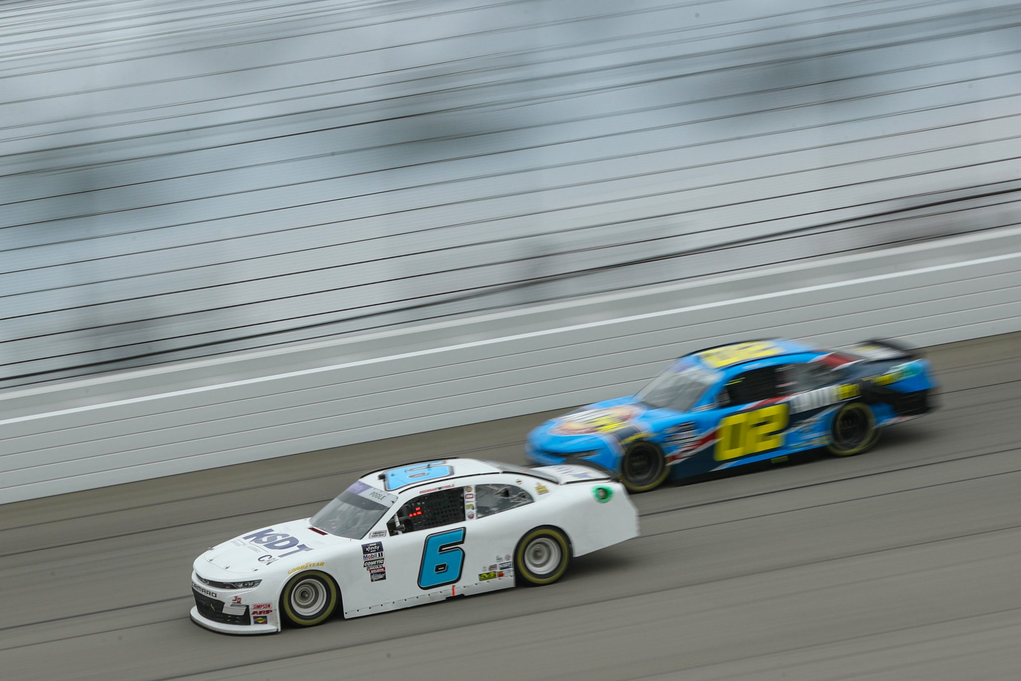 BROOKLYN, MICHIGAN - AUGUST 05: Brennan Poole, driver of the #6 KSDT Chevrolet, and Blaine Perkins, driver of the #02 AutoParkit.com Chevrolet, race during the NASCAR Xfinity Series Cabo Wabo 250 at Michigan International Speedway on August 05, 2023 in Brooklyn, Michigan. (Photo by Meg Oliphant/Getty Images) | Getty Images