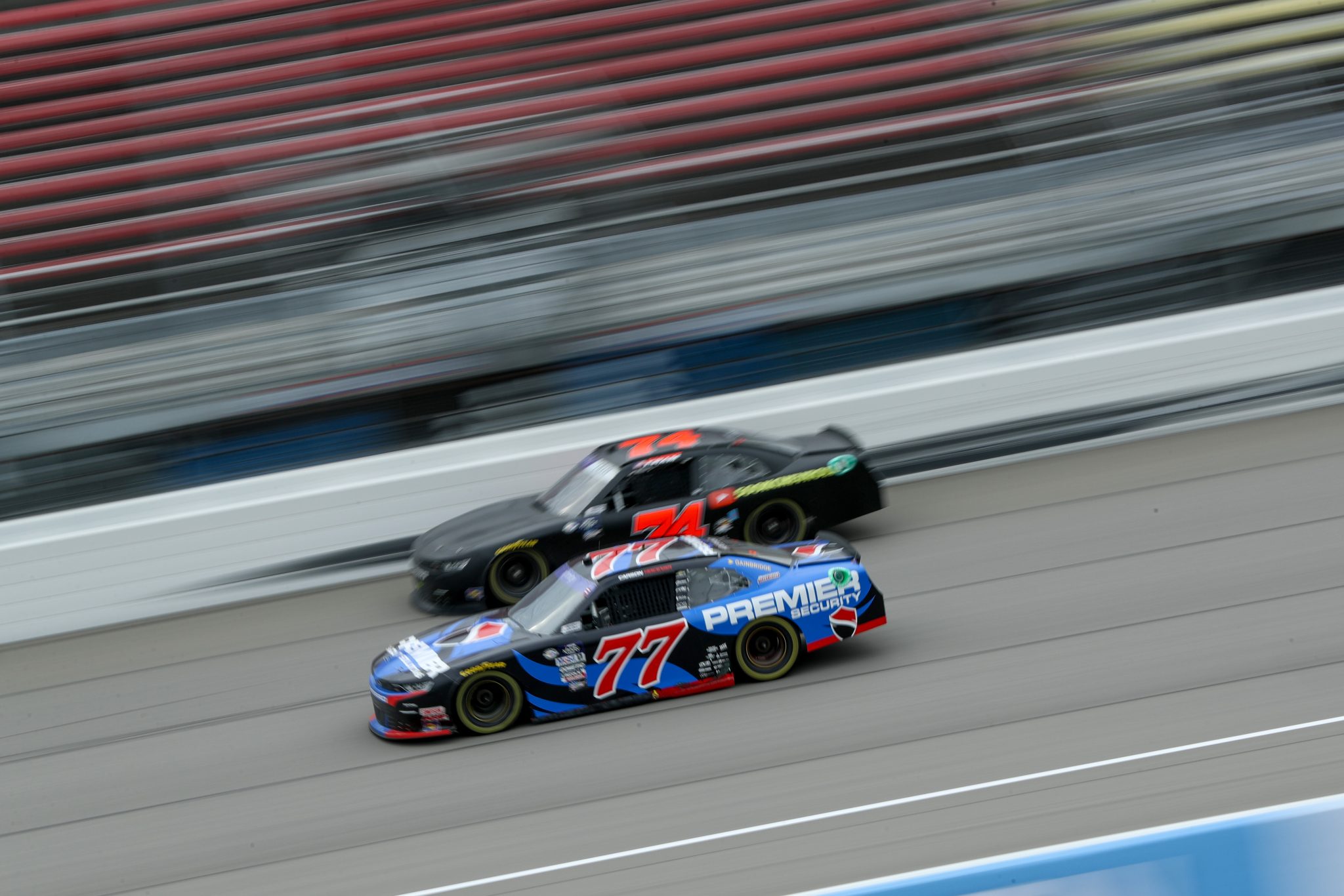 BROOKLYN, MICHIGAN - AUGUST 05: Carson Hocevar, driver of the #77 Premier Security Chevrolet, and Dawson Cram, driver of the #74 CHK Racing Chevrolet, race during the NASCAR Xfinity Series Cabo Wabo 250 at Michigan International Speedway on August 05, 2023 in Brooklyn, Michigan. (Photo by Meg Oliphant/Getty Images) | Getty Images