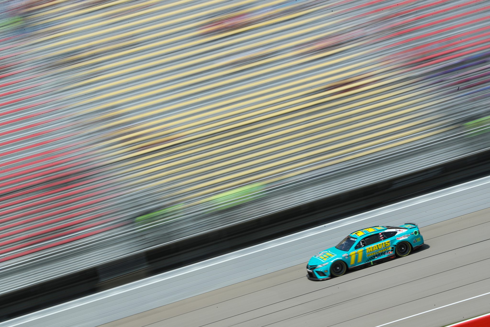BROOKLYN, MICHIGAN - AUGUST 05: Denny Hamlin, driver of the #11 Mavis Tires & Brakes Toyota, drives during qualifying for the NASCAR Cup Series FireKeepers Casino 400 at Michigan International Speedway on August 05, 2023 in Brooklyn, Michigan. (Photo by Meg Oliphant/Getty Images) | Getty Images