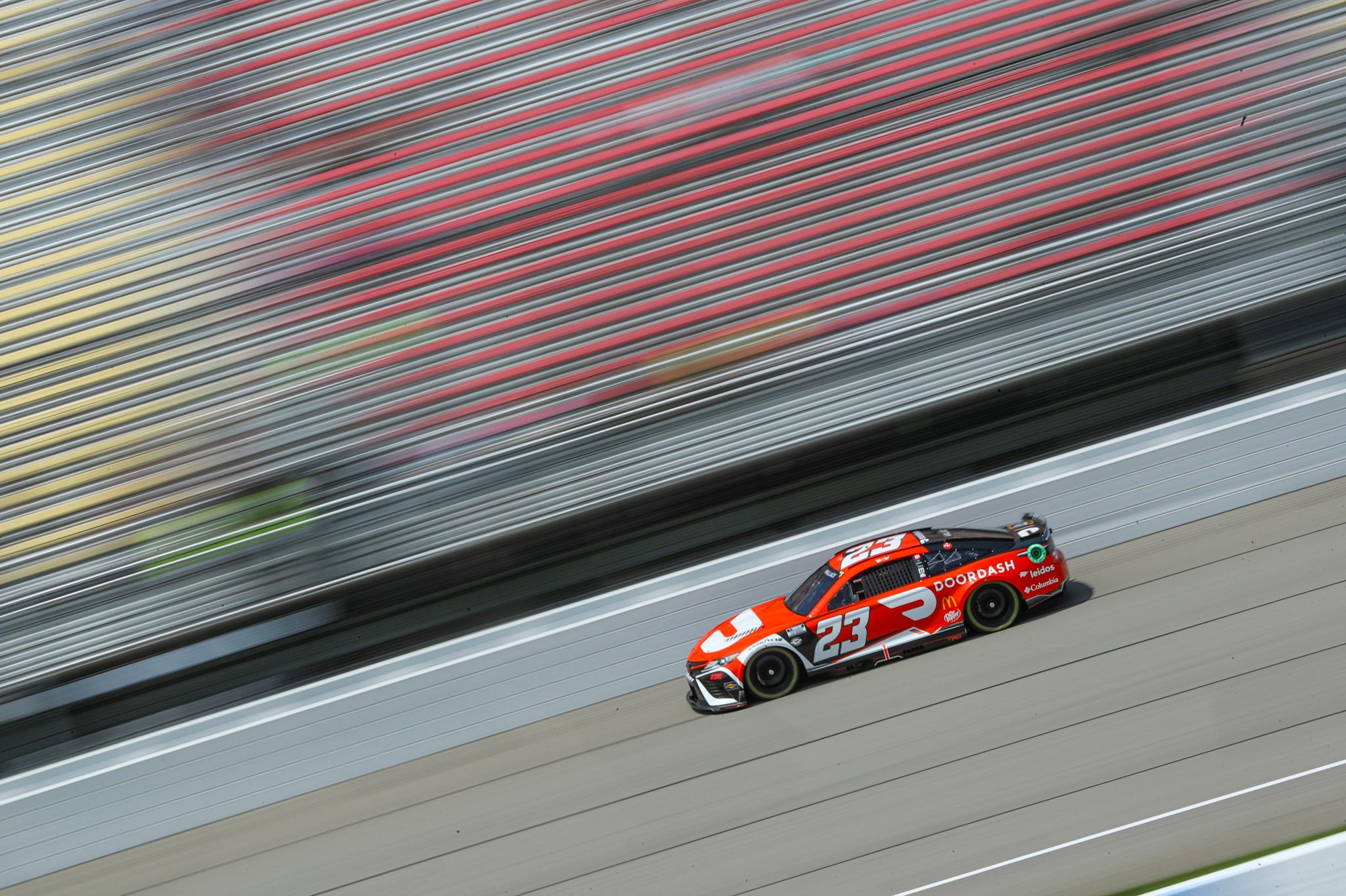 BROOKLYN, MICHIGAN - AUGUST 05: Bubba Wallace, driver of the #23 DoorDash Toyota, drives during practice for the NASCAR Cup Series FireKeepers Casino 400 at Michigan International Speedway on August 05, 2023 in Brooklyn, Michigan. (Photo by Meg Oliphant/Getty Images) | Getty Images