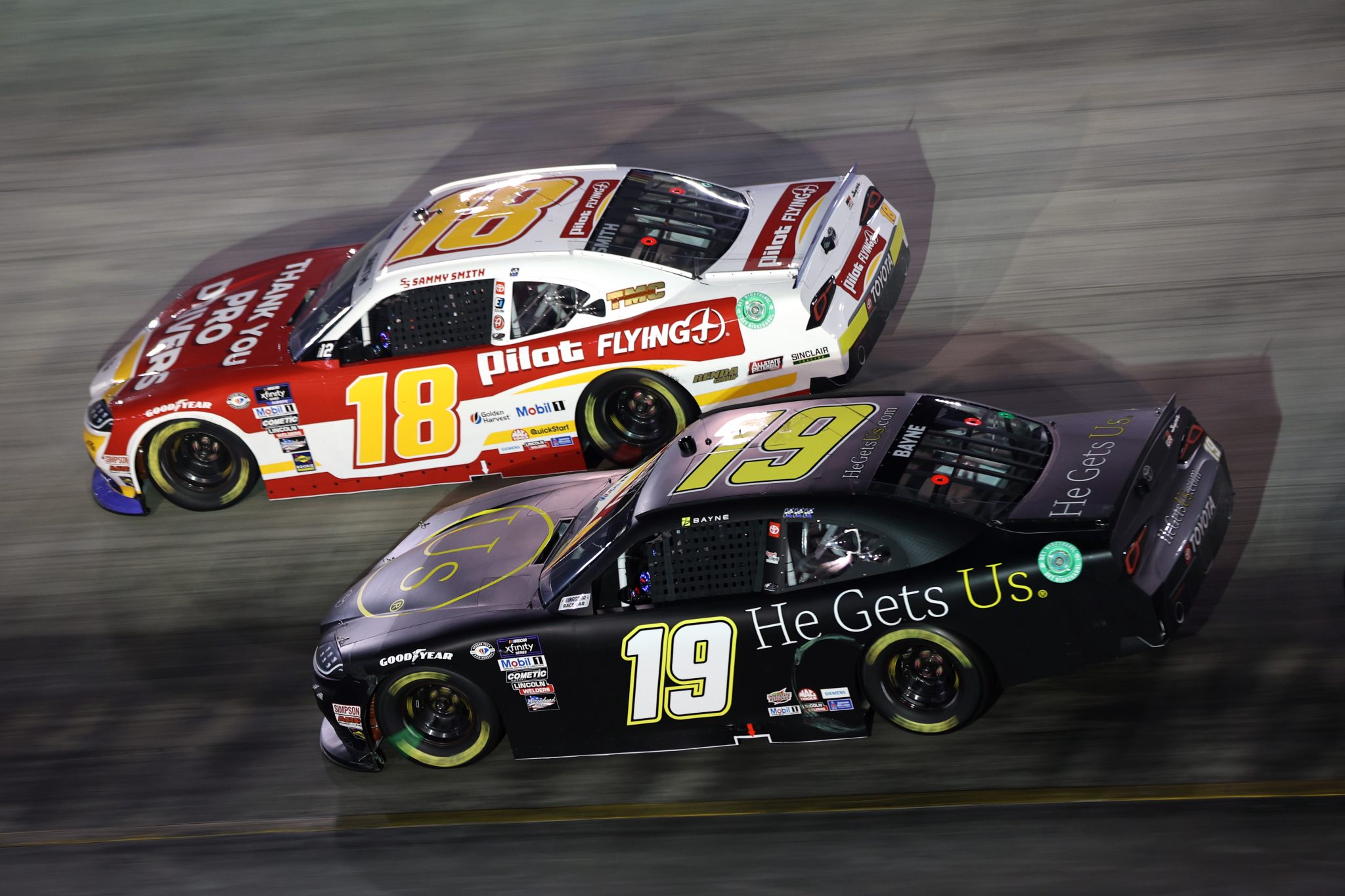 BRISTOL, TENNESSEE - SEPTEMBER 15: Sammy Smith, driver of the #18 Pilot Flying J Toyota, and Trevor Bayne, driver of the #19 He Gets Us Toyota, race during the NASCAR Xfinity Series Food City 300 at Bristol Motor Speedway on September 15, 2023 in Bristol, Tennessee. (Photo by Jared C. Tilton/Getty Images) | Getty Images