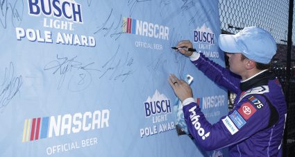 DARLINGTON, SOUTH CAROLINA - SEPTEMBER 02: Christopher Bell, driver of the #20 Yahoo! Toyota, signs the Busch Light Pole Award backdrop after winning the pole award during qualifying for the NASCAR Cup Series Cook Out Southern 500 at Darlington Raceway on September 02, 2023 in Darlington, South Carolina. (Photo by James Gilbert/Getty Images) | Getty Images