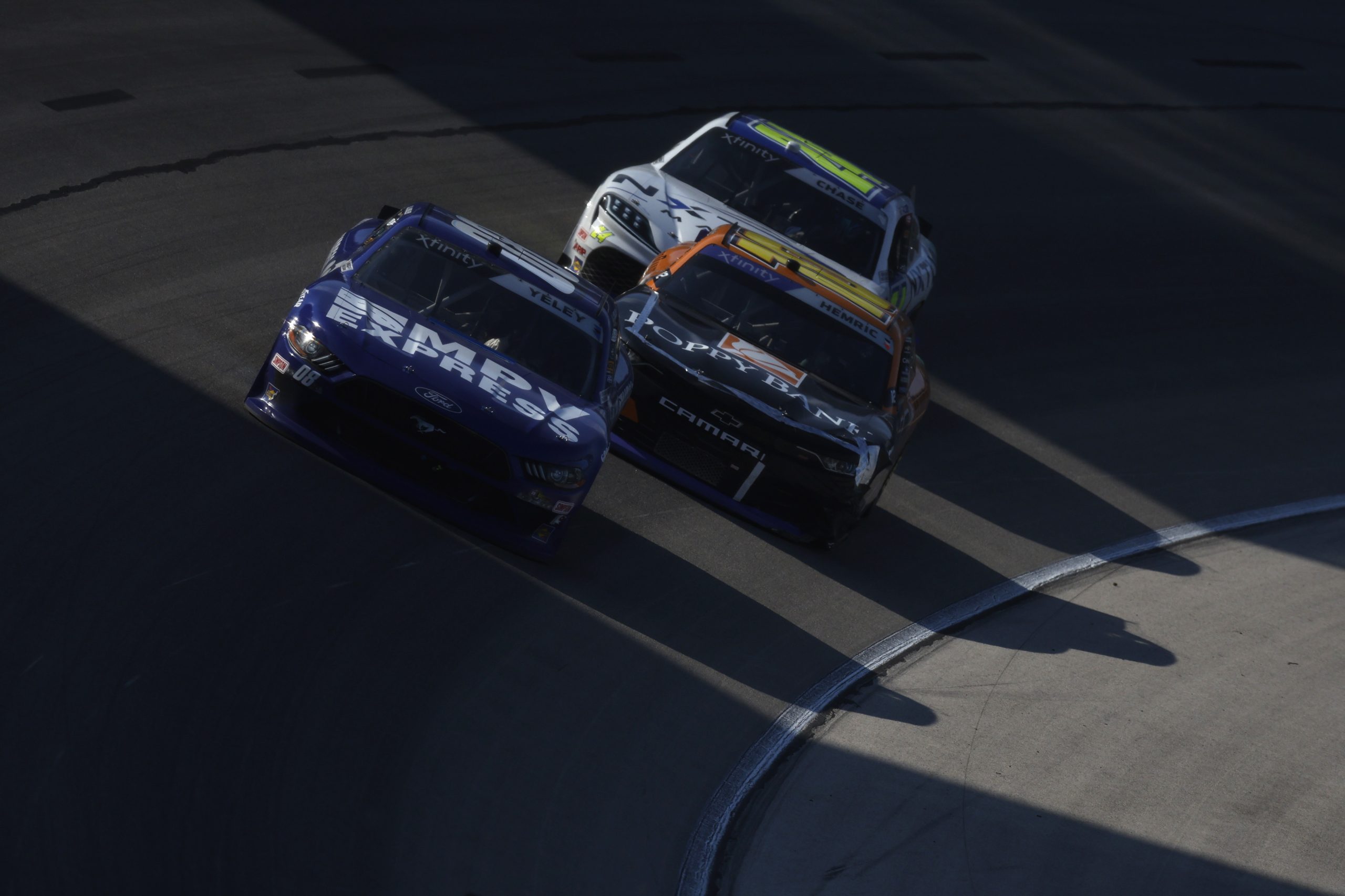 FORT WORTH, TEXAS - SEPTEMBER 23: JJ Yeley, driver of the #08 MPV Express Ford, Daniel Hemric, driver of the #10 Poppy Bank Chevrolet, and Parker Chase, driver of the #24 NXTLVL Marine/Ontivity Toyota, race during the NASCAR Xfinity Series Andy's Frozen Custard 300 at Texas Motor Speedway on September 23, 2023 in Fort Worth, Texas. (Photo by Sean Gardner/Getty Images) | Getty Images
