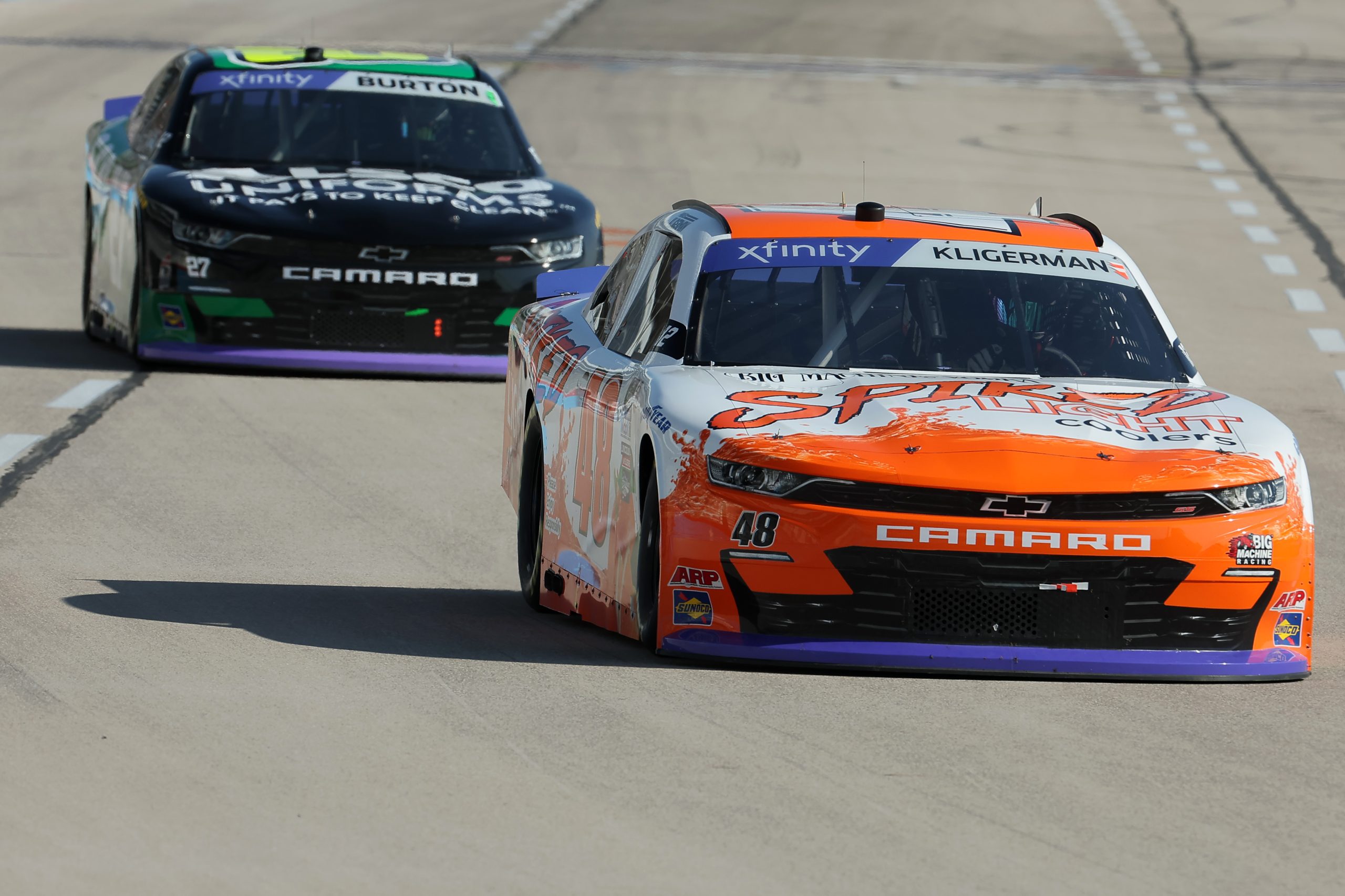 FORT WORTH, TEXAS - SEPTEMBER 23: Parker Kligerman, driver of the #48 Spiked Light Coolers Chevrolet, and Jeb Burton, driver of the #27 Alsco Uniforms Chevrolet, drive during practice for the NASCAR Xfinity Series Andy's Frozen Custard 300 - Practice at Texas Motor Speedway on September 23, 2023 in Fort Worth, Texas. (Photo by Jonathan Bachman/Getty Images) | Getty Images
