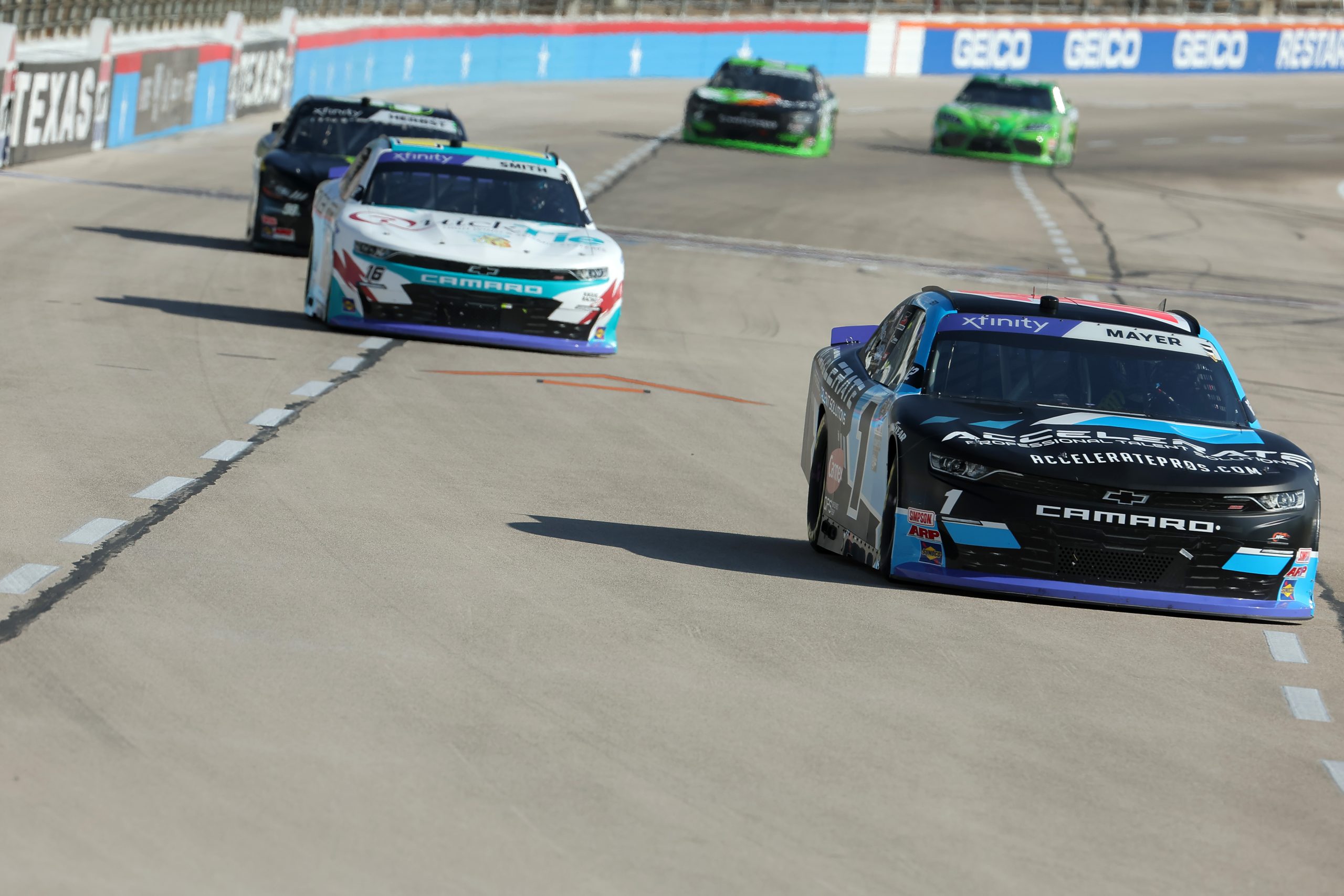 FORT WORTH, TEXAS - SEPTEMBER 23: Sam Mayer, driver of the #1 Accelerate Pros Talent Chevrolet, and Chandler Smith, driver of the #16 Quick Tie Products Inc Chevrolet, drive during practice for the NASCAR Xfinity Series Andy's Frozen Custard 300 - Practice at Texas Motor Speedway on September 23, 2023 in Fort Worth, Texas. (Photo by Jonathan Bachman/Getty Images) | Getty Images