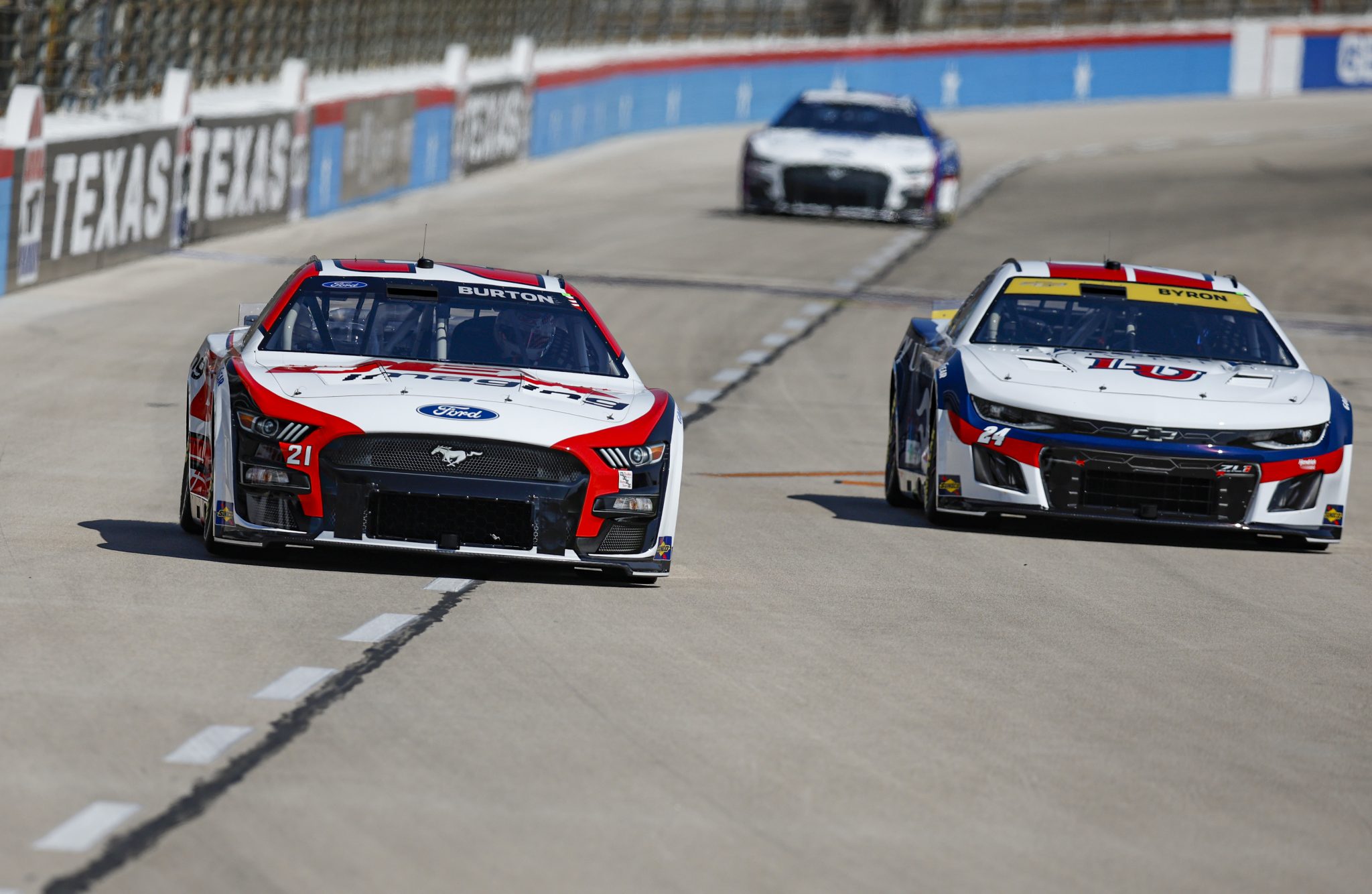 FORT WORTH, TEXAS - SEPTEMBER 23: Harrison Burton, driver of the #21 DEX Imaging Ford, and William Byron, driver of the #24 Liberty University Chevrolet, drive during practice for the NASCAR Cup Series Autotrader EchoPark Automotive 400 at Texas Motor Speedway on September 23, 2023 in Fort Worth, Texas. (Photo by Sean Gardner/Getty Images) | Getty Images