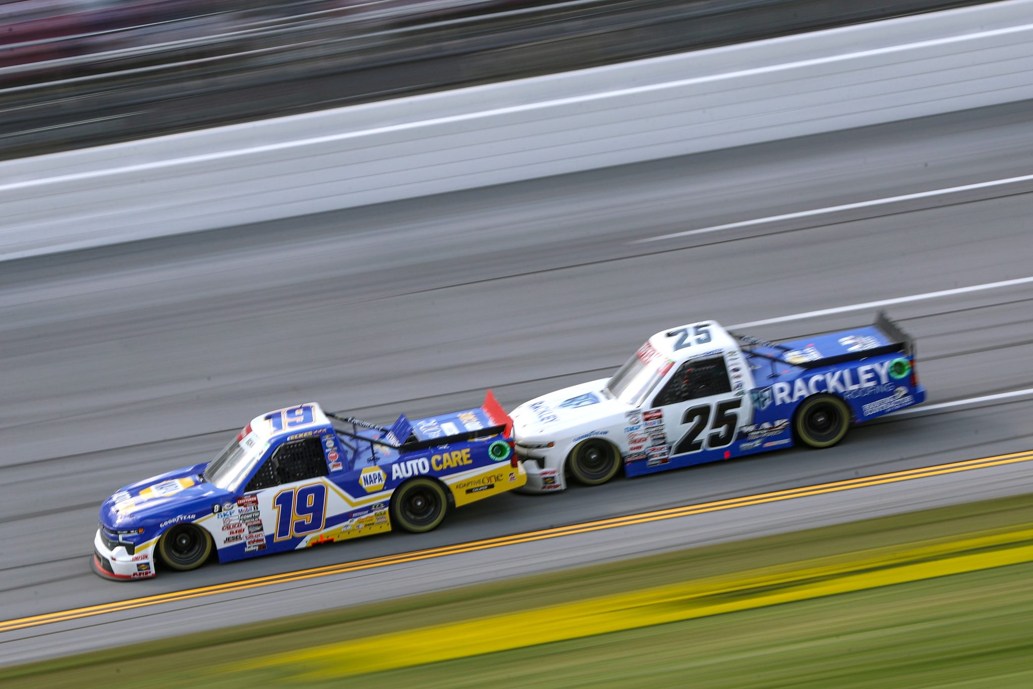 TALLADEGA, ALABAMA - SEPTEMBER 30: Christian Eckes, driver of the #19 NAPA Auto Care Chevrolet, and Chandler Smith, driver of the #25 Rackley Roofing Chevrolet, race during the NASCAR Craftsman Truck Series Love's RV Stop 250 at Talladega Superspeedway on September 30, 2023 in Talladega, Alabama. (Photo by Meg Oliphant/Getty Images) | Getty Images