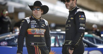 AUSTIN, TEXAS - MARCH 25: Noah Gragson, driver of the #42 Black Rifle Coffee Company Chevrolet, (L) and Jimmie Johnson, driver of the #84 Club Wyndham Chevrolet, look on in the garage area during qualifying for the NASCAR Cup Series EchoPark Automotive Grand Prix at Circuit of The Americas on March 25, 2023 in Austin, Texas. (Photo by Chris Graythen/Getty Images) | Getty Images