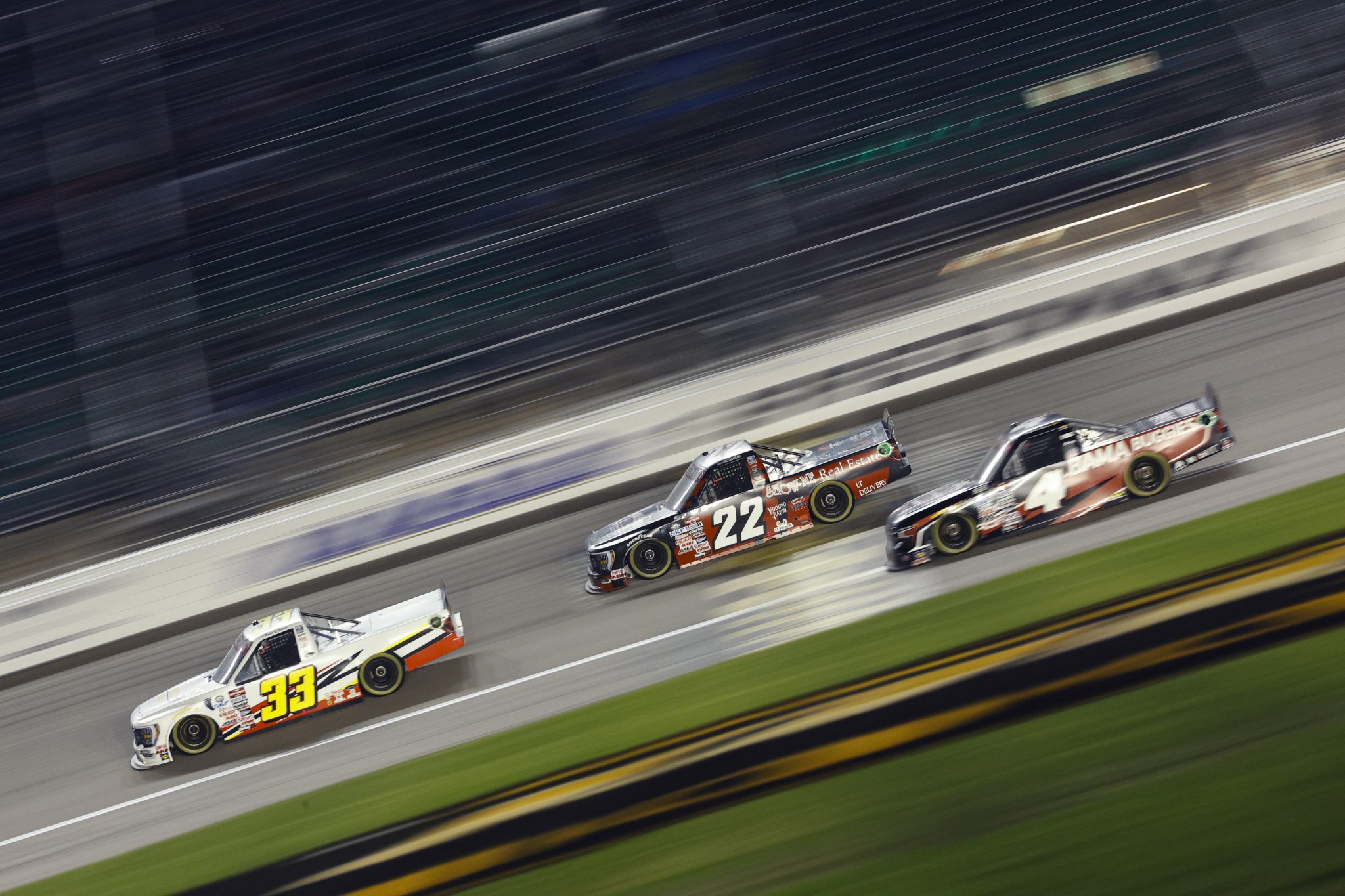 KANSAS CITY, KANSAS - SEPTEMBER 08: Chase Janes, driver of the #33 Butlerbuilt Ford, Mason Maggio, driver of the #22 Professional AG Services Ford, and Chase Purdy, driver of the #4 Bama Buggies Chevrolet, race during the NASCAR Craftsman Truck Series Kansas Lottery 200 at Kansas Speedway on September 08, 2023 in Kansas City, Kansas. (Photo by Sean Gardner/Getty Images) | Getty Images