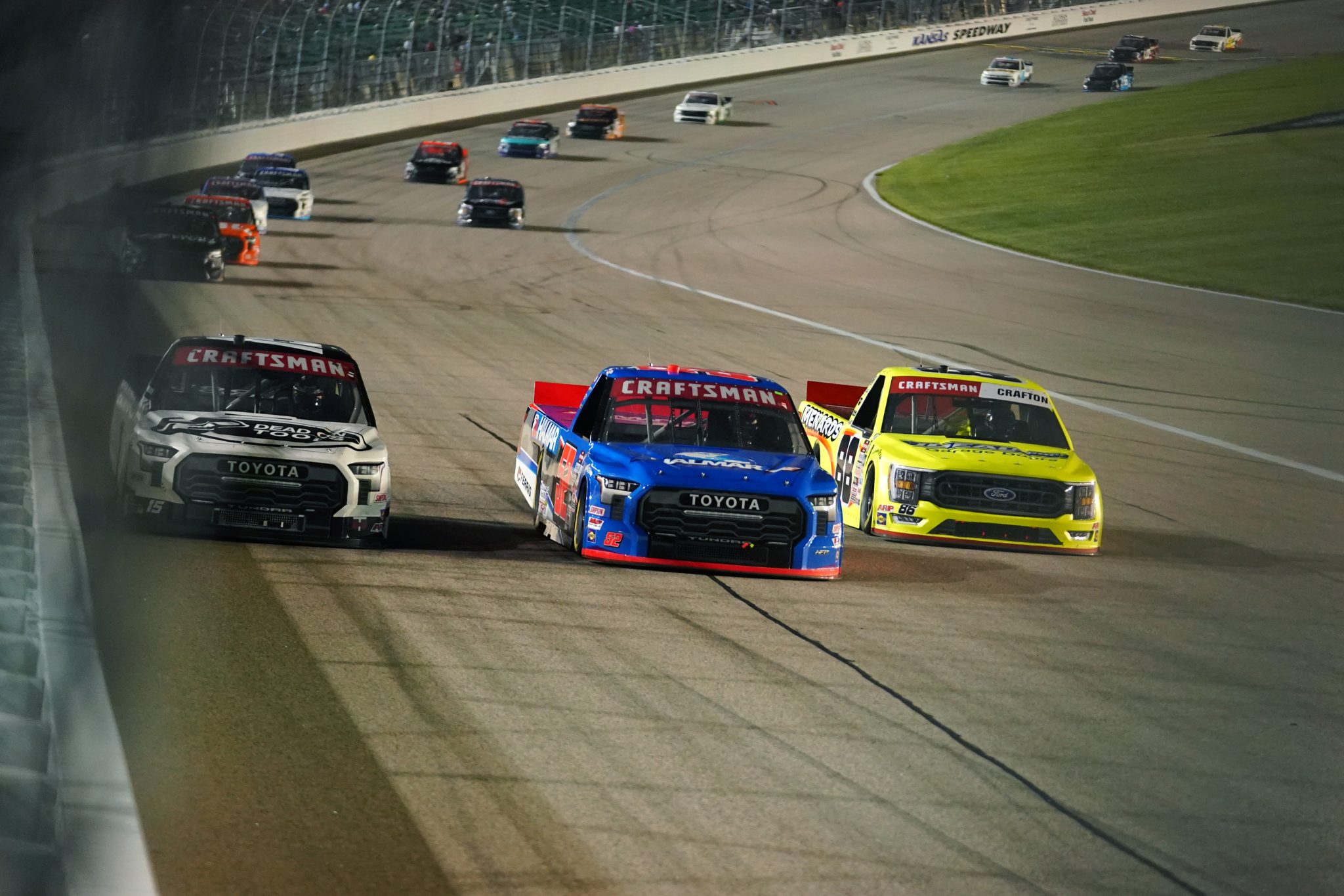KANSAS CITY, KANSAS - SEPTEMBER 08: Stewart Friesen, driver of the #52 Halmar International Toyota, Matt Crafton, driver of the #88 Flex Seal/Menards Ford, and Tanner Gray, driver of the #15 Dead On Tools Toyota, race during the NASCAR Craftsman Truck Series Kansas Lottery 200 at Kansas Speedway on September 08, 2023 in Kansas City, Kansas. (Photo by Kyle Rivas/Getty Images) | Getty Images