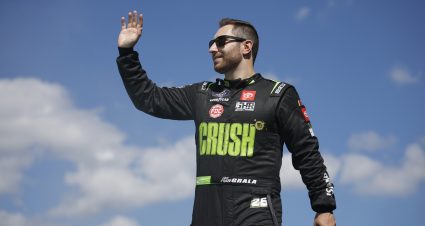 HOMESTEAD, FLORIDA - OCTOBER 21: Kaz Grala, driver of the #26 CRUSH Lemonade Toyota, waves to fans as he walks onstage during driver intros prior to the NASCAR Xfinity Series Contender Boats 300 at Homestead-Miami Speedway on October 21, 2023 in Homestead, Florida. (Photo by James Gilbert/Getty Images) | Getty Images