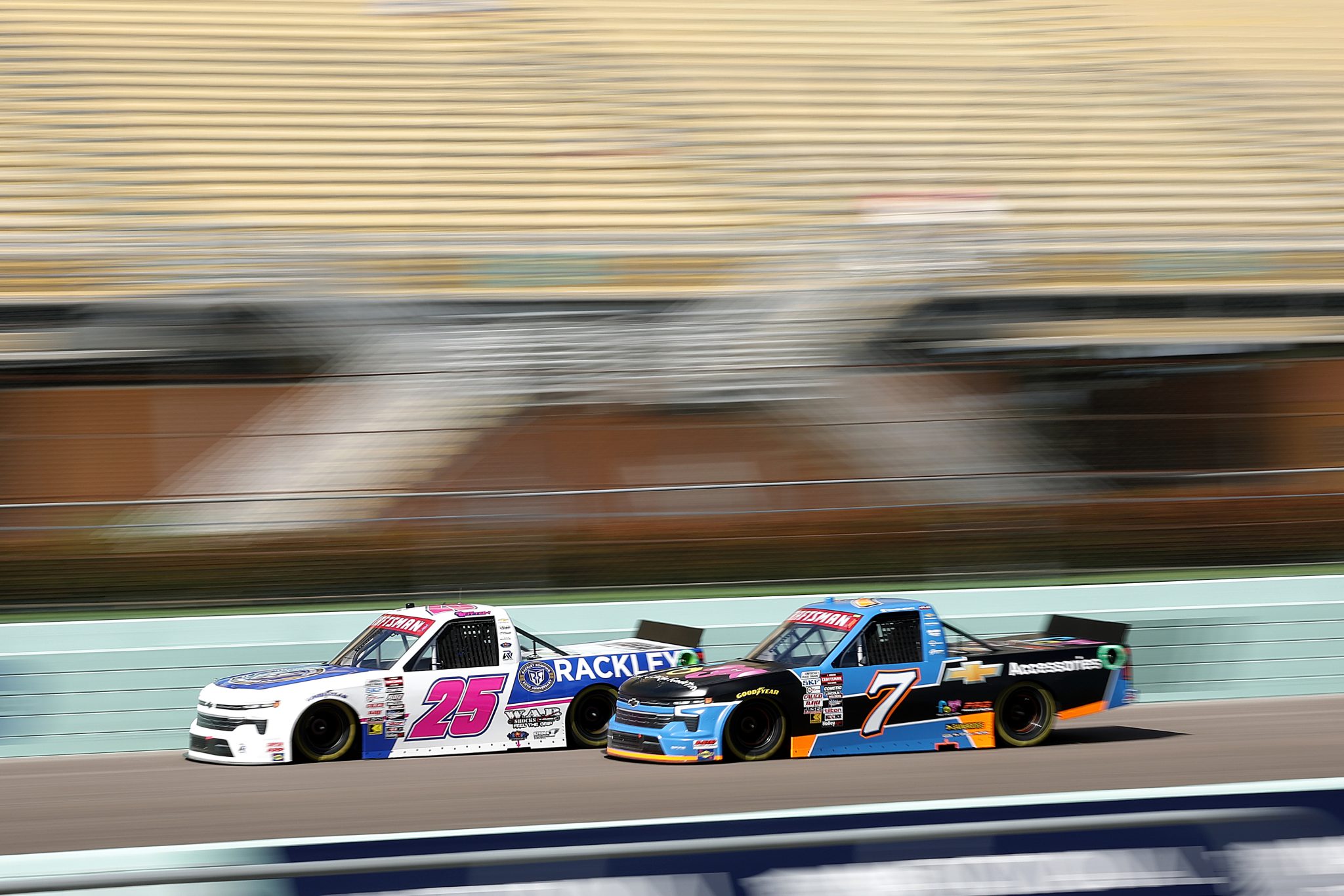 HOMESTEAD, FLORIDA - OCTOBER 25: Dawson Sutton, driver of the #25 Rackley Roofing Chevrolet, and Connor Mosack, driver of the #7 Friends of Jaclyn Foundation Chevrolet, drive during qualifying for the NASCAR Craftsman Truck Series Baptist Health 200 at Homestead-Miami Speedway on October 25, 2024 in Homestead, Florida. (Photo by James Gilbert/Getty Images) | Getty Images