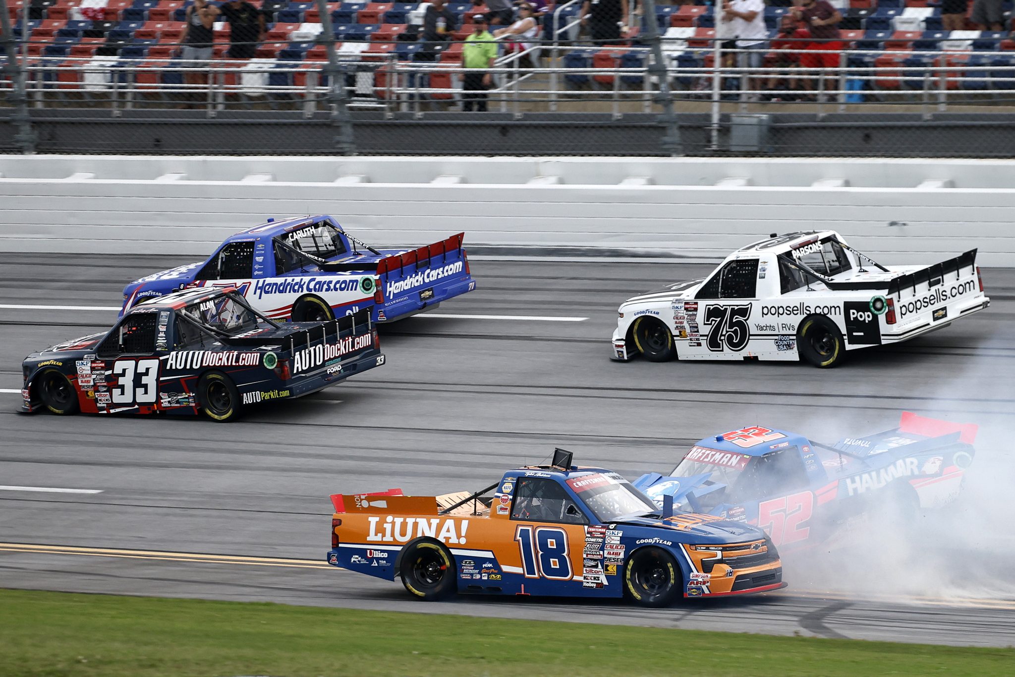 TALLADEGA, ALABAMA - OCTOBER 04: Tyler Ankrum, driver of the #18 LiUNA! Chevrolet, and Stewart Friesen, driver of the #52 Halmar International Toyota, spin after an on-track incident during the NASCAR Craftsman Truck Series Love's RV Stop 225 at Talladega Superspeedway on October 04, 2024 in Talladega, Alabama. (Photo by Chris Graythen/Getty Images) | Getty Images