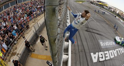 TALLADEGA, ALABAMA - OCTOBER 06: Ricky Stenhouse Jr., driver of the #47 Kroger Health/Palmolive Chevrolet, climbs the fence to celebrate with fans after winning the NASCAR Cup Series YellaWood 500 at Talladega Superspeedway on October 06, 2024 in Talladega, Alabama. (Photo by Sean Gardner/Getty Images) | Getty Images