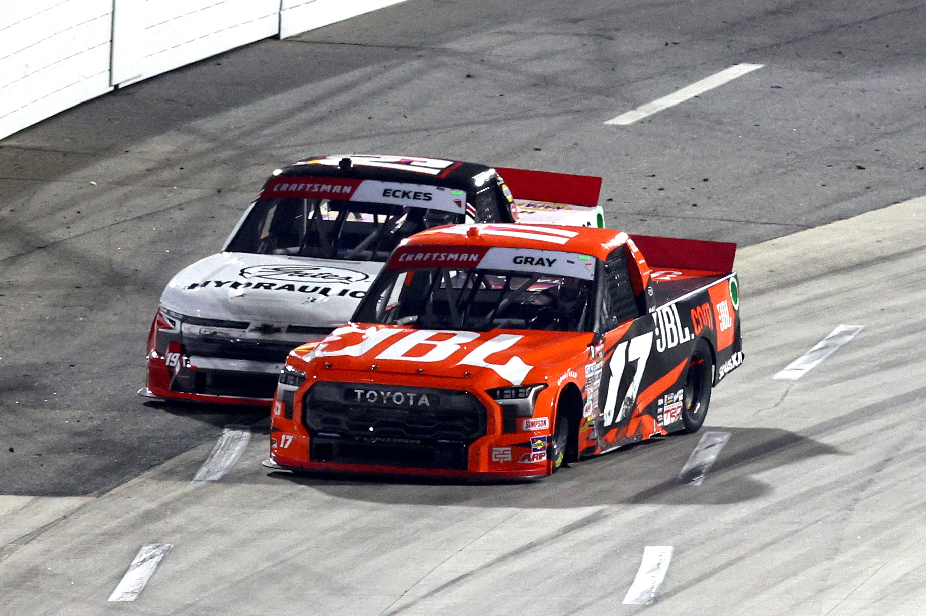MARTINSVILLE, VIRGINIA - NOVEMBER 01: Taylor Gray, driver of the #17 JBL Toyota, bumps Christian Eckes, driver of the #19 Gates Hydraulics Chevrolet, after Eckes won the NASCAR Craftsman Truck Series Zip Buy Now, Pay Later 200 at Martinsville Speedway on November 01, 2024 in Martinsville, Virginia. (Photo by Jared C. Tilton/Getty Images) | Getty Images