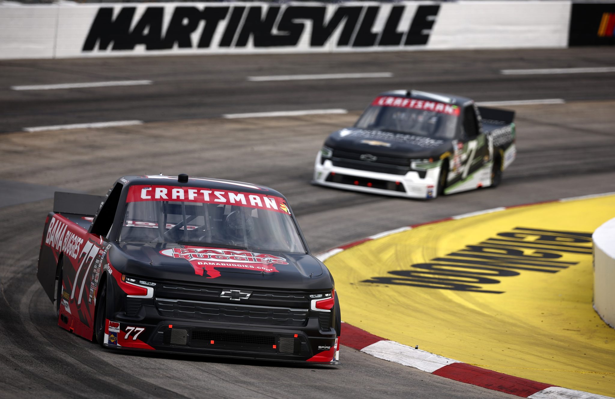 MARTINSVILLE, VIRGINIA - NOVEMBER 01: Chase Purdy, driver of the #77 Bama Buggies Chevrolet, and Connor Zilisch, driver of the #7 Austin Hatcher Foundation Chevrolet, drive during practice for the NASCAR Craftsman Truck Series Zip Buy Now, Pay Later 200 at Martinsville Speedway on November 01, 2024 in Martinsville, Virginia. (Photo by Jared C. Tilton/Getty Images) | Getty Images