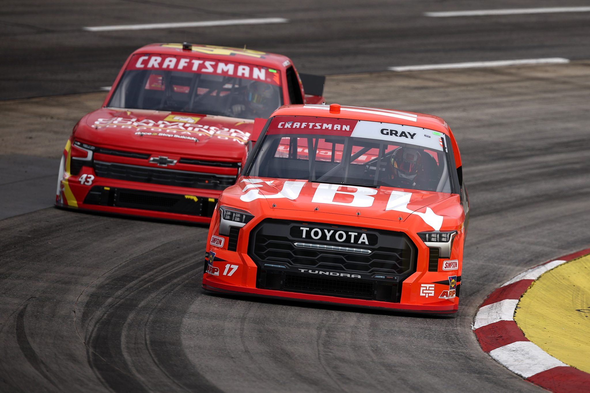 MARTINSVILLE, VIRGINIA - NOVEMBER 01: Taylor Gray, driver of the #17 JBL Toyota, and Daniel Dye, driver of the #43 Champion Container Chevrolet, drive during practice for the NASCAR Craftsman Truck Series Zip Buy Now, Pay Later 200 at Martinsville Speedway on November 01, 2024 in Martinsville, Virginia. (Photo by Jared C. Tilton/Getty Images) | Getty Images