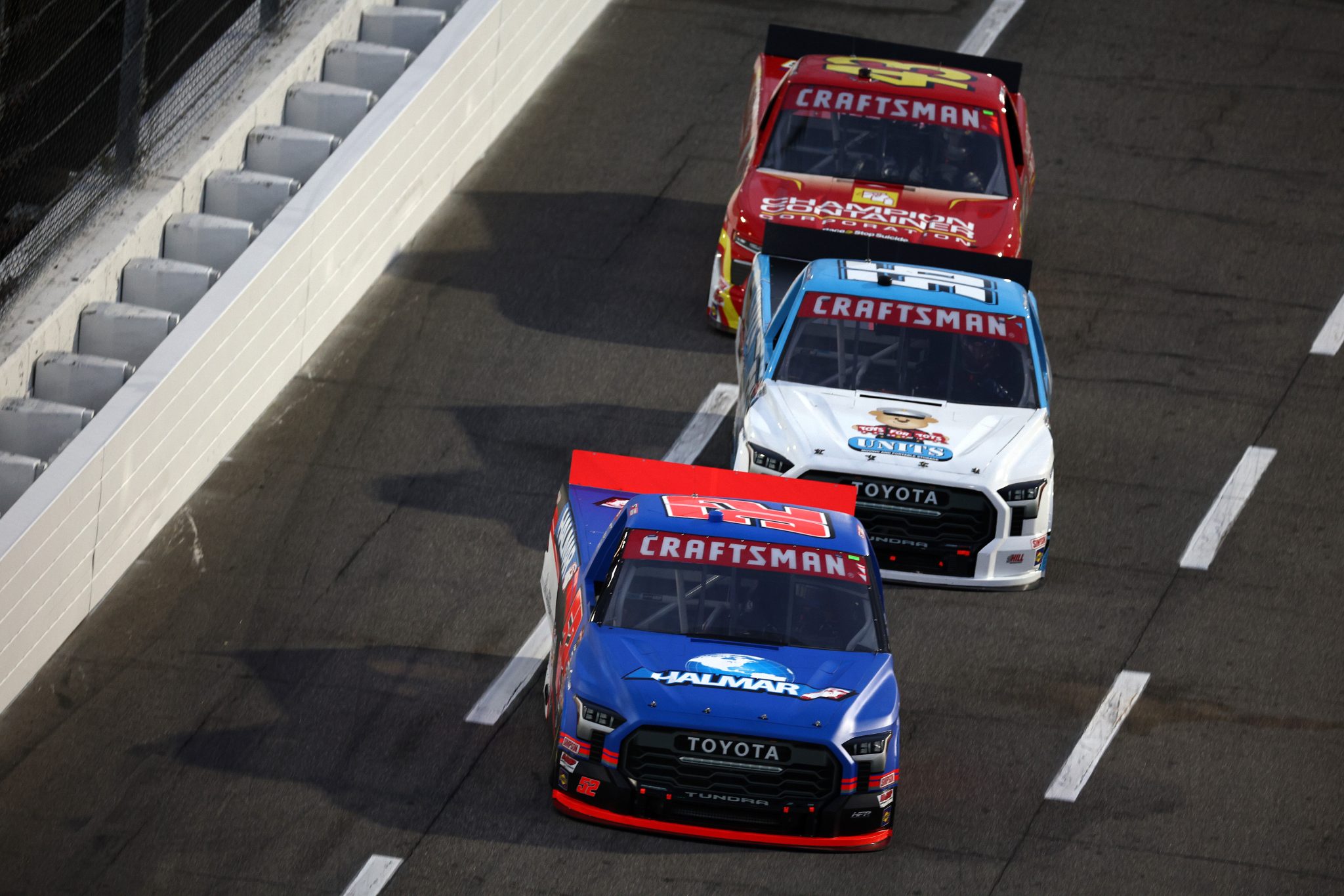 MARTINSVILLE, VIRGINIA - NOVEMBER 01: Stewart Friesen, driver of the #52 Halmar International Toyota, Timmy Hill, driver of the #56 UNITS/Toys for Tots Toyota, and Daniel Dye, driver of the #43 Champion Container Chevrolet, race during the NASCAR Craftsman Truck Series Zip Buy Now, Pay Later 200 at Martinsville Speedway on November 01, 2024 in Martinsville, Virginia. (Photo by Jared C. Tilton/Getty Images) | Getty Images