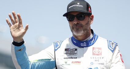 FORT WORTH, TEXAS - APRIL 14: Jimmie Johnson, driver of the #84 AdventHealth Toyota, waves to fans as he walks onstage during driver intros prior to the NASCAR Cup Series AutoTrader EchoPark Automotive 400 at Texas Motor Speedway on April 14, 2024 in Fort Worth, Texas. (Photo by Sean Gardner/Getty Images) | Getty Images