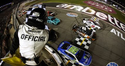HAMPTON, GEORGIA - FEBRUARY 25: Daniel Suarez, driver of the #99 Freeway Insurance Chevrolet, crosses the finish line ahead of Kyle Busch, driver of the #8 Cheddar's Scratch Kitchen Chevrolet, and Ryan Blaney, driver of the #12 BodyArmor Zero Sugar Ford, to win the NASCAR Cup Series Ambetter Health 400 at Atlanta Motor Speedway on February 25, 2024 in Hampton, Georgia. (Photo by Alex Slitz/Getty Images) | Getty Images