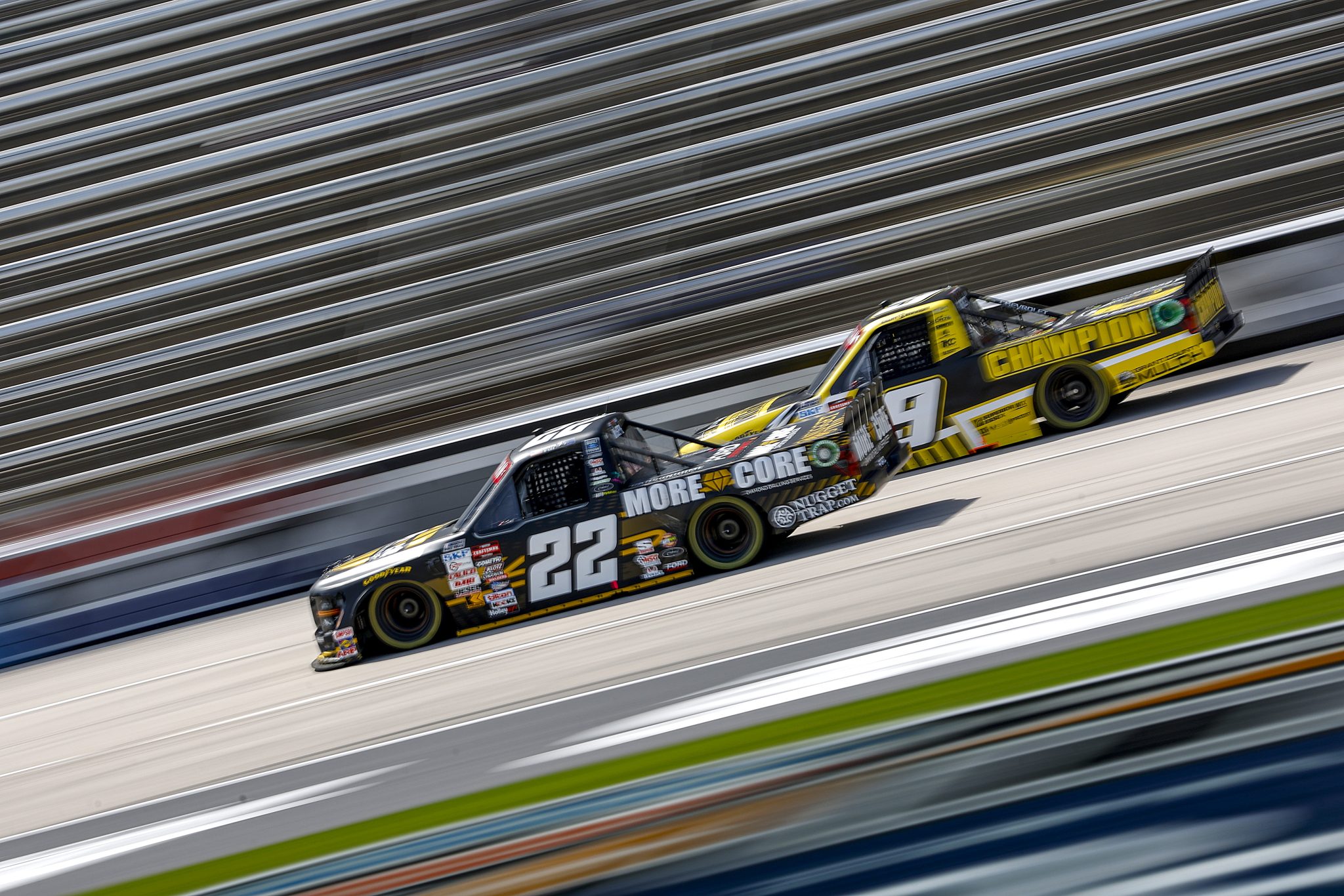 FORT WORTH, TEXAS - APRIL 12: Keith McGee, driver of the #22 More Core Ford, and Grant Enfinger, driver of the #9 Champion Power Equipment Chevrolet, drive during practice for the NASCAR Craftsman Truck Series SpeedyCash.com 250 at Texas Motor Speedway on April 12, 2024 in Fort Worth, Texas. (Photo by Sean Gardner/Getty Images) | Getty Images