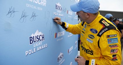 TALLADEGA, ALABAMA - APRIL 20: Michael McDowell, driver of the #34 Love's Travel Stops Ford, signs the Busch Light Pole Award backdrop after winning the pole award during qualifying for the NASCAR Cup Series GEICO 500 at Talladega Superspeedway on April 20, 2024 in Talladega, Alabama. (Photo by Sean Gardner/Getty Images) | Getty Images