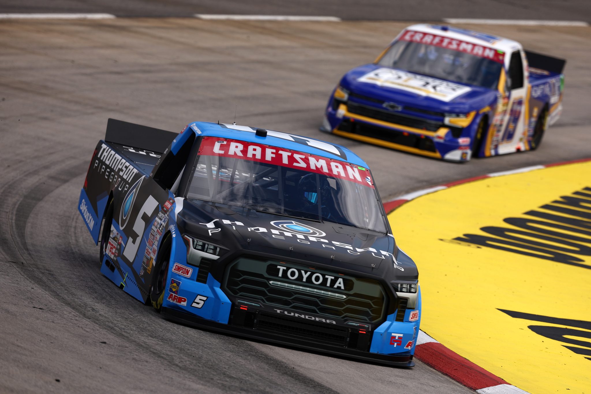 MARTINSVILLE, VIRGINIA - APRIL 05: Dean Thompson, driver of the #5 Thompson Pipe Group Toyota, and Christian Eckes, driver of the #19 Adaptive One Calipers Chevrolet, drive during practice for the NASCAR Craftsman Long John Silver's 200 at Martinsville Speedway on April 05, 2024 in Martinsville, Virginia. (Photo by Jared C. Tilton/Getty Images) | Getty Images