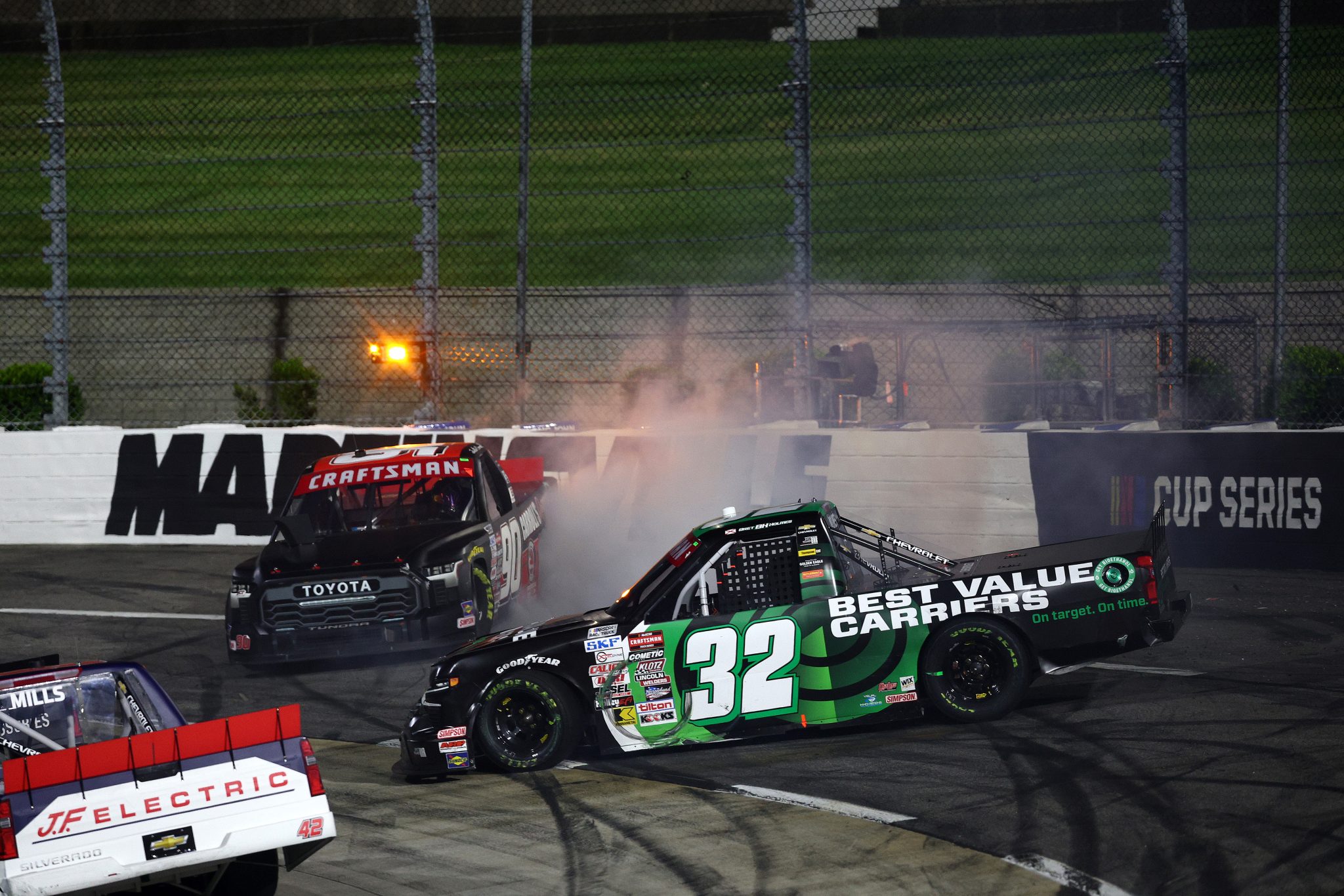 MARTINSVILLE, VIRGINIA - APRIL 05: Bret Holmes, driver of the #32 Best Value Carriers Chevrolet, and Justin Carroll, driver of the #90 Carroll's Automotive/Duratain Toyota, spin after an on-track incident during the NASCAR Craftsman Long John Silver's 200 at Martinsville Speedway on April 05, 2024 in Martinsville, Virginia. (Photo by Jared C. Tilton/Getty Images) | Getty Images