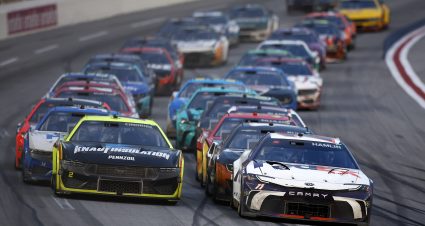 HAMPTON, GEORGIA - FEBRUARY 25: Denny Hamlin, driver of the #11 FedEx Toyota, and Austin Cindric, driver of the #2 Menards/Knauf Insulation Ford, lead the field during the NASCAR Cup Series Ambetter Health 400 at Atlanta Motor Speedway on February 25, 2024 in Hampton, Georgia. (Photo by Alex Slitz/Getty Images) | Getty Images