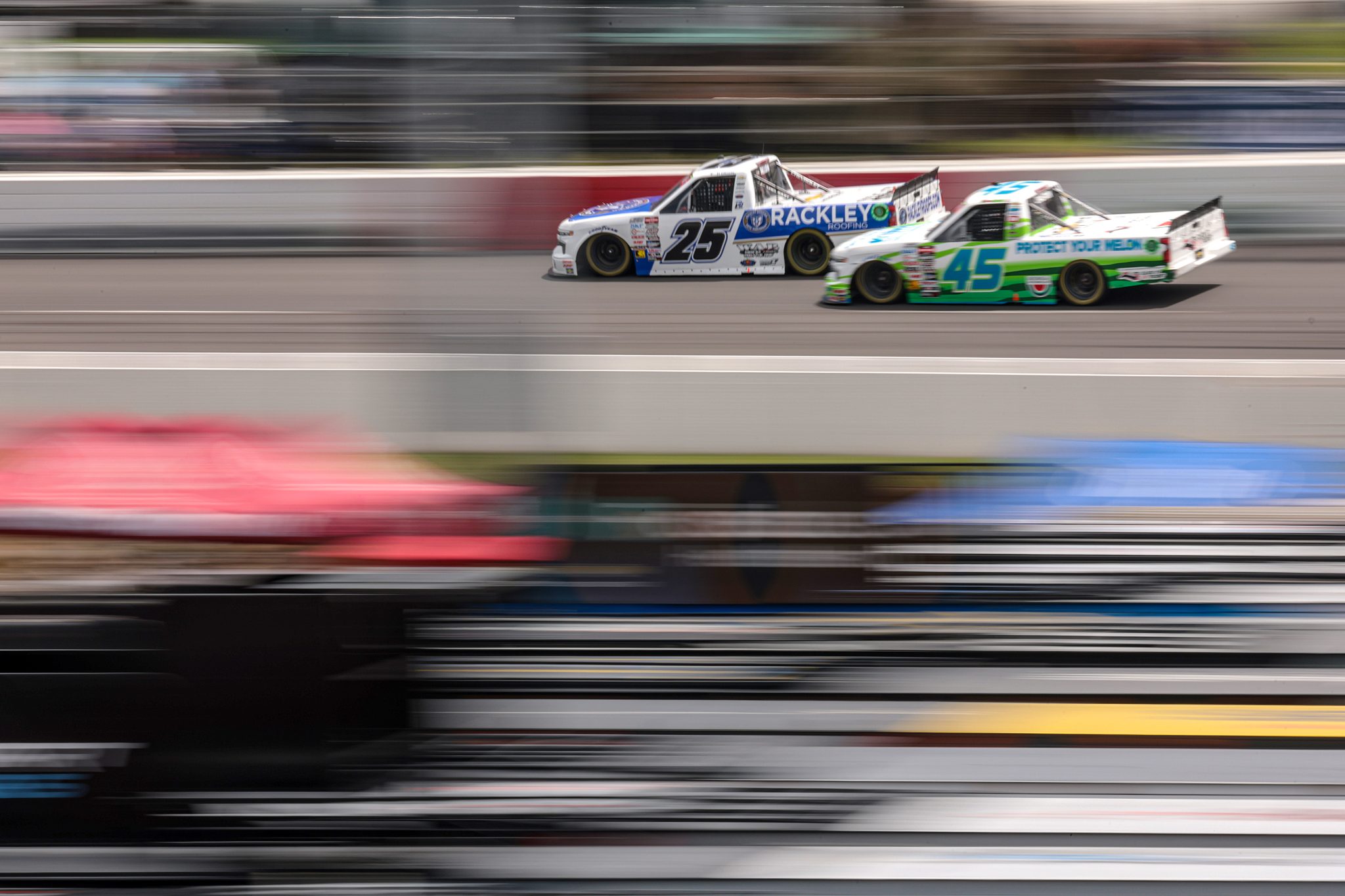 NORTH WILKESBORO, NORTH CAROLINA - MAY 19: Ty Dillon, driver of the #25 Rackley Roofing Chevrolet, and Ross Chastain, driver of the #45 NC Governor's Hwy Safety Program Chevrolet, race during the NASCAR Craftsman Truck Series Wright Brand 250 at North Wilkesboro Speedway on May 19, 2024 in North Wilkesboro, North Carolina. (Photo by James Gilbert/Getty Images) | Getty Images