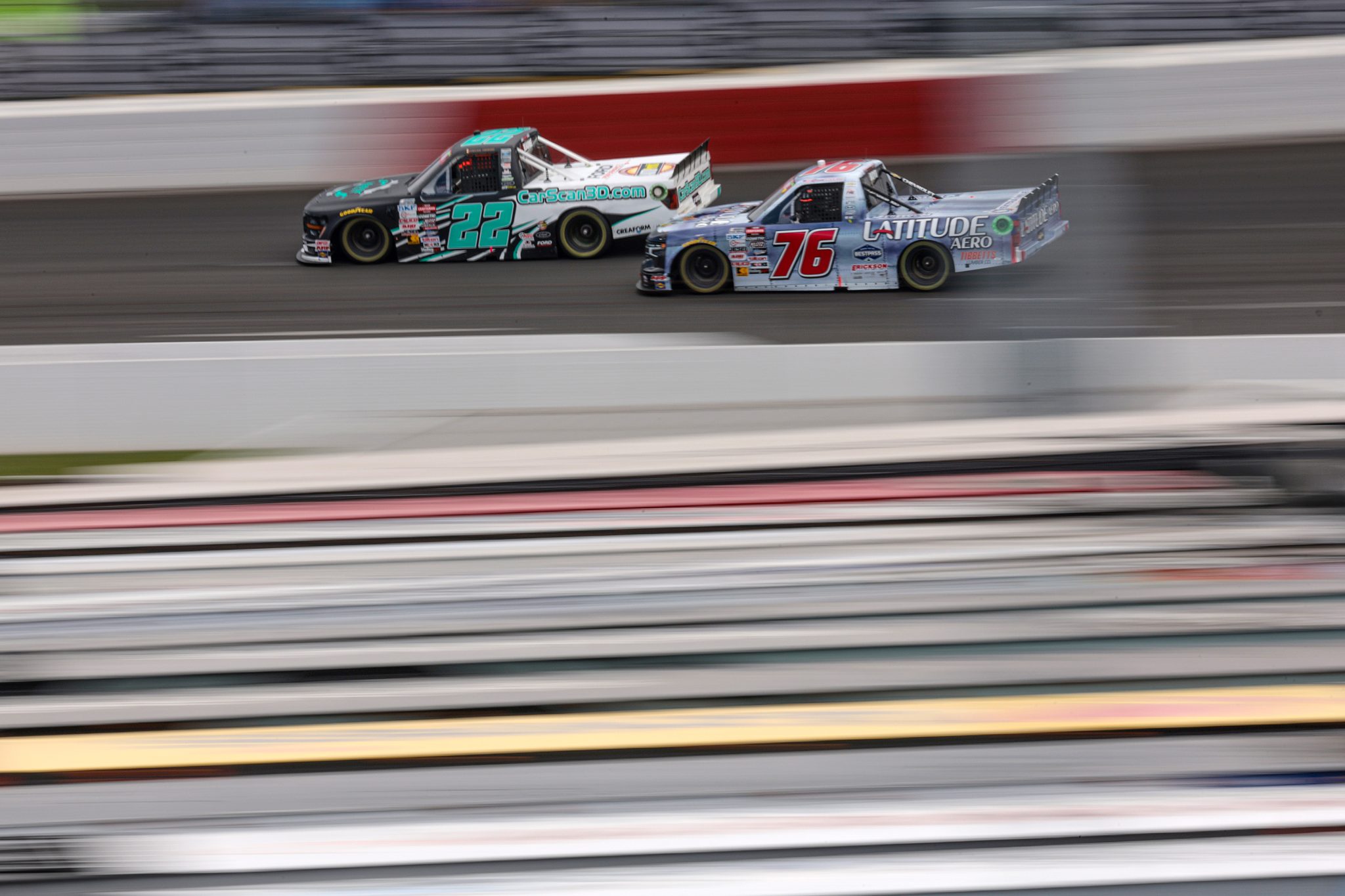 NORTH WILKESBORO, NORTH CAROLINA - MAY 19: Josh Reaume, driver of the #22 Matrix CAD Design Ford, and Spencer Boyd, driver of the #76 Latitude Aero Chevrolet, race during the NASCAR Craftsman Truck Series Wright Brand 250 at North Wilkesboro Speedway on May 19, 2024 in North Wilkesboro, North Carolina. (Photo by James Gilbert/Getty Images) | Getty Images