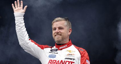 TALLADEGA, ALABAMA - APRIL 20: Justin Allgaier, driver of the #7 BRANDT Chevrolet, waves to fans as he walks onstage during driver intros prior to the NASCAR Xfinity Series Ag-Pro 300 at Talladega Superspeedway on April 20, 2024 in Talladega, Alabama. (Photo by Sean Gardner/Getty Images) | Getty Images