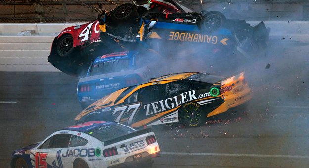 TALLADEGA, ALABAMA - APRIL 21: Josh Berry, driver of the #4 Overstock.com Ford, Ryan Preece, driver of the #41 United Rentals Ford, Corey LaJoie, driver of the #7 Gainbridge Chevrolet, and Carson Hocevar, driver of the #77 Zeigler Auto Group Chevrolet, spin into the wall after an on-track incident on the final lap of the NASCAR Cup Series GEICO 500 at Talladega Superspeedway on April 21, 2024 in Talladega, Alabama. (Photo by James Gilbert/Getty Images) | Getty Images