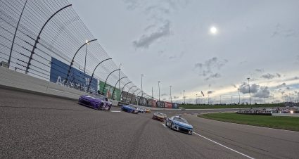 KANSAS CITY, KANSAS - MAY 05: Christopher Bell, driver of the #20 Yahoo! Toyota, and Ross Chastain, driver of the #1 Busch Light Crocs Chevrolet, lead the field on a pace lap prior to the NASCAR Cup Series AdventHealth 400 at Kansas Speedway on May 05, 2024 in Kansas City, Kansas. (Photo by Sean Gardner/Getty Images) | Getty Images