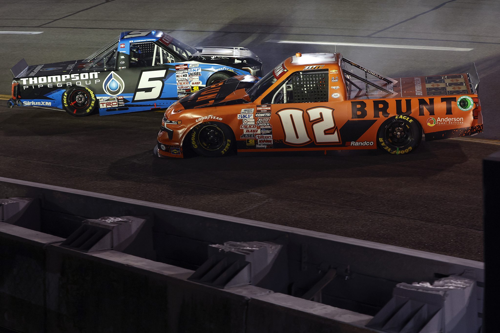 RICHMOND, VIRGINIA - AUGUST 10: Dean Thompson, driver of the #5 Thompson Pipe Group Toyota, and Mason Massey, driver of the #02 BRUNT Chevrolet, spin after an on-track incident during the NASCAR Craftsman Truck Series Clean Harbors 250 at Richmond Raceway on August 10, 2024 in Richmond, Virginia. (Photo by Sean Gardner/Getty Images) | Getty Images