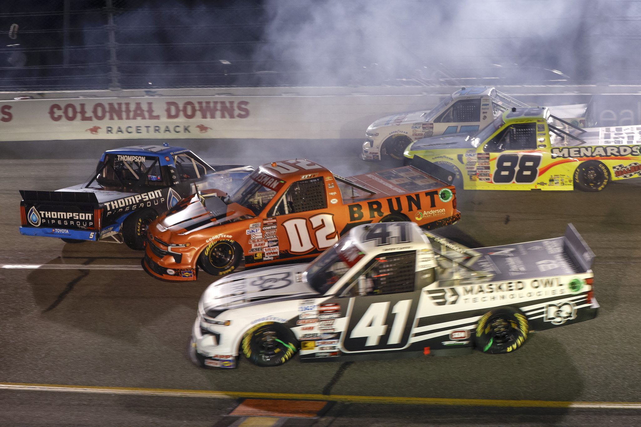 RICHMOND, VIRGINIA - AUGUST 10: Dean Thompson, driver of the #5 Thompson Pipe Group Toyota, and Mason Massey, driver of the #02 BRUNT Chevrolet, spin after an on-track incident during the NASCAR Craftsman Truck Series Clean Harbors 250 at Richmond Raceway on August 10, 2024 in Richmond, Virginia. (Photo by Sean Gardner/Getty Images) | Getty Images