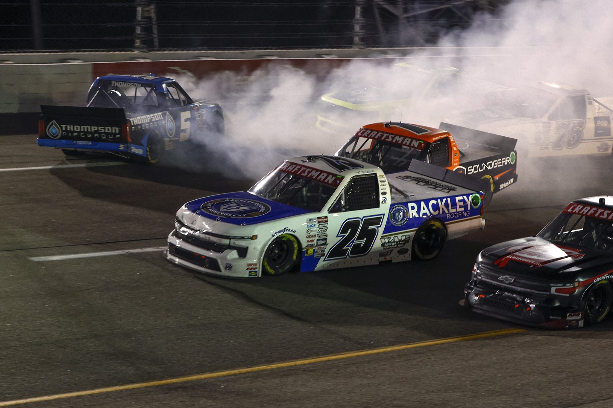 RICHMOND, VIRGINIA - AUGUST 10: Dean Thompson, driver of the #5 Thompson Pipe Group Toyota, spins after an on-track incident as Ty Dillon, driver of the #25 Rackley Roofing Chevrolet, and William Sawalich, driver of the #1 Starkey/Soundgear Toyota, pass during the NASCAR Craftsman Truck Series Clean Harbors 250 at Richmond Raceway on August 10, 2024 in Richmond, Virginia. (Photo by Sean Gardner/Getty Images) | Getty Images