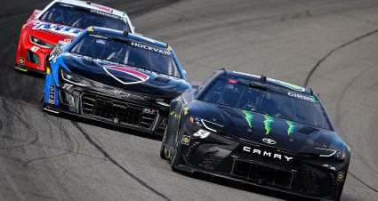 BROOKLYN, MICHIGAN - AUGUST 18: Ty Gibbs, driver of the #54 Monster Energy Toyota, Carson Hocevar, driver of the #77 Premier Security/Zeigler.com Chevrolet, and Ricky Stenhouse Jr., driver of the #47 Country Crock/Minute Rice Chevrolet, race during the NASCAR Cup Series FireKeepers Casino 400 at Michigan International Speedway on August 18, 2024 in Brooklyn, Michigan. (Photo by Jonathan Bachman/Getty Images) | Getty Images