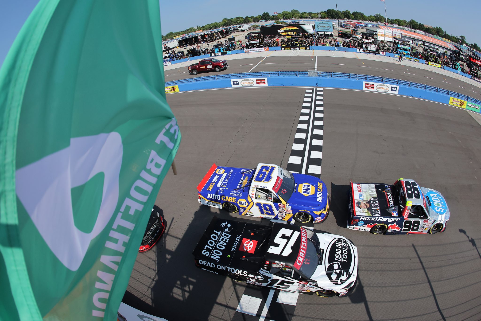 WEST ALLIS, WISCONSIN - AUGUST 25: Ty Majeski, driver of the #98 Road Ranger/Soda Sense Ford, leads Christian Eckes, driver of the #19 NAPA Auto Care Chevrolet, and Tanner Gray, driver of the #15 Dead On Tools Toyota, to the green flag to start the NASCAR Craftsman Truck Series The Milwaukee Mile at The Milwaukee Mile on August 25, 2024 in West Allis, Wisconsin. (Photo by Jonathan Bachman/Getty Images) | Getty Images