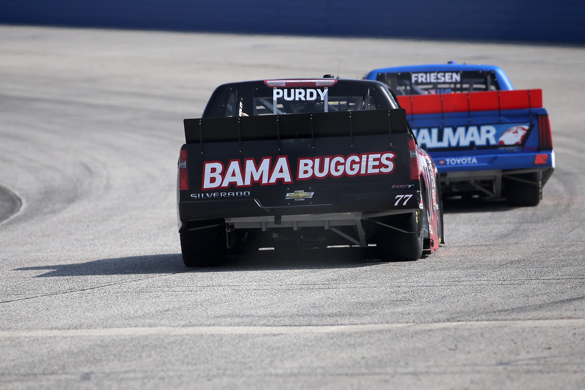 WEST ALLIS, WISCONSIN - AUGUST 25: Chase Purdy, driver of the #77 Bama Buggies Chevrolet, and Stewart Friesen, driver of the #52 Halmar International Toyota, race during the NASCAR Craftsman Truck Series The Milwaukee Mile at The Milwaukee Mile on August 25, 2024 in West Allis, Wisconsin. (Photo by Jonathan Bachman/Getty Images) | Getty Images