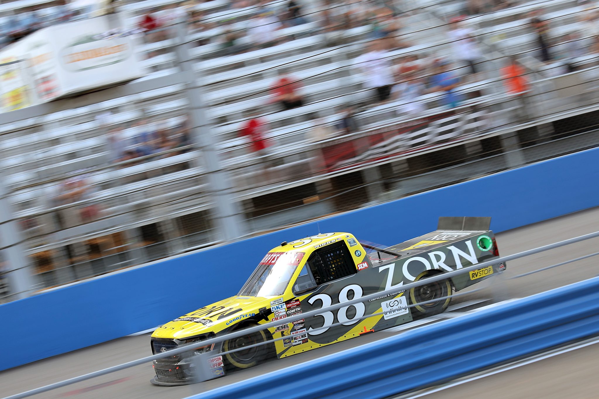 WEST ALLIS, WISCONSIN - AUGUST 25: Layne Riggs, driver of the #38 Zorn Compressor & Equipment Ford, crosses the finish line to win the NASCAR Craftsman Truck Series The Milwaukee Mile at The Milwaukee Mile on August 25, 2024 in West Allis, Wisconsin. (Photo by Jonathan Bachman/Getty Images) | Getty Images
