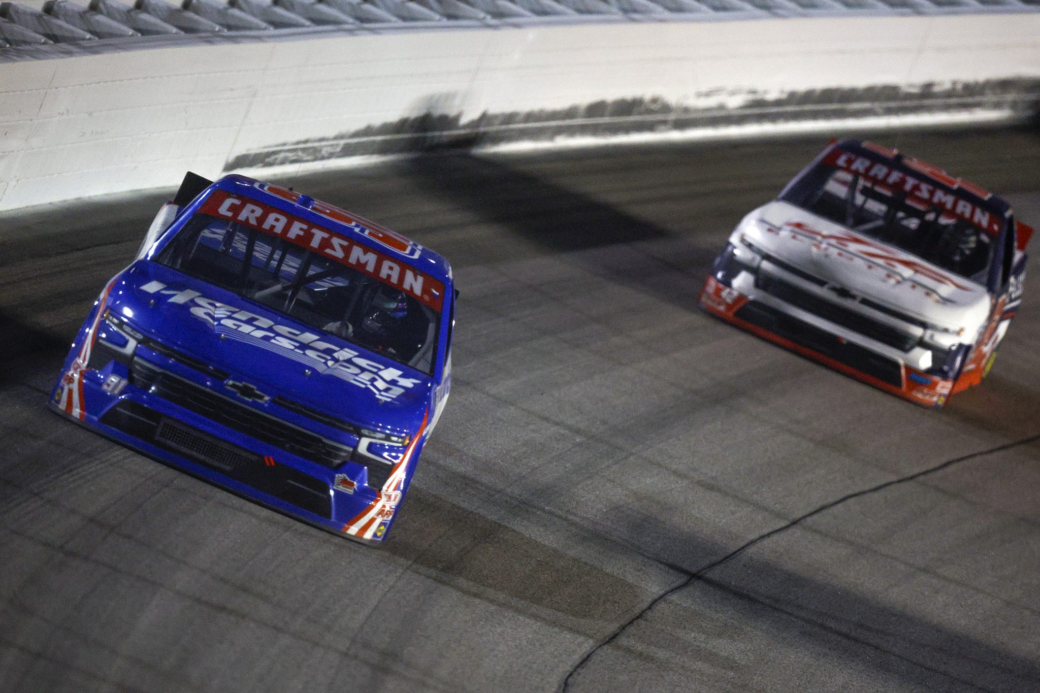 KANSAS CITY, KANSAS - SEPTEMBER 27: Corey Day, driver of the #91 HendrickCars.com Chevrolet, and Matt Mills, driver of the #42 J.F. Electric/Utilitra Chevrolet, race during the NASCAR Craftsman Truck Series Kubota Tractor 200 at Kansas Speedway on September 27, 2024 in Kansas City, Kansas. (Photo by Sean Gardner/Getty Images) | Getty Images